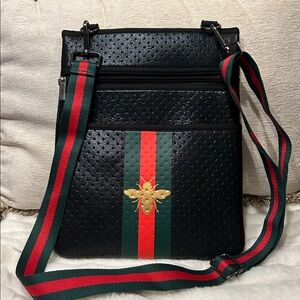 Black Crossbody Bag with Gold Bee and Striped Strap